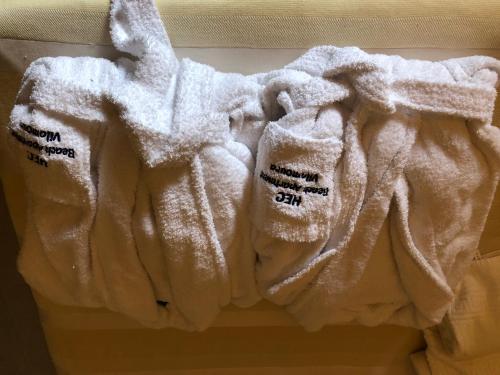a pile of white towels hanging on a wall at Beach Apartment Marina Vilamoura in Vilamoura