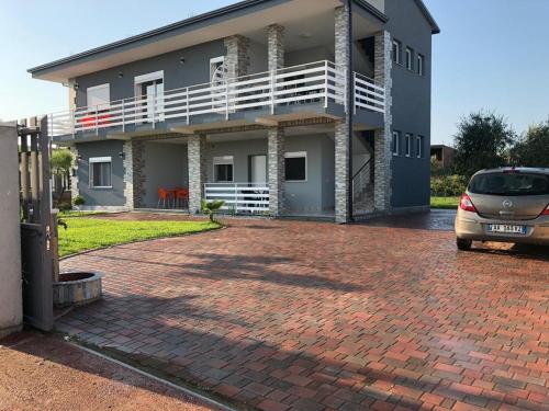 a house with a car parked in front of it at Palma Apartments in Durrës