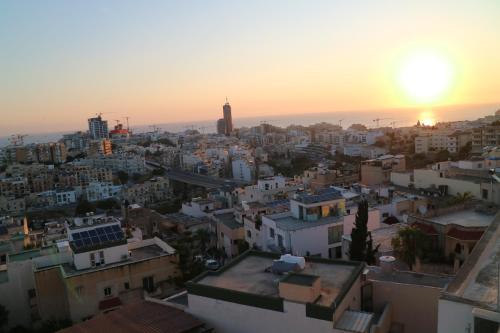 an aerial view of a city at sunset at Escape to St Julians in St Julian's