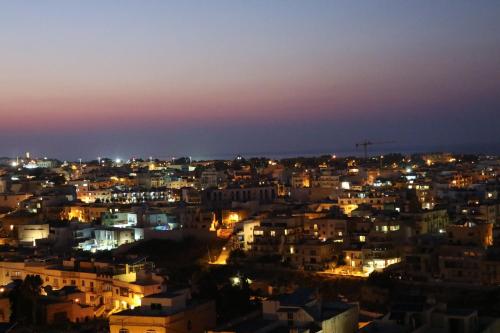 a view of a city at night at Escape to St Julians in St Julian's
