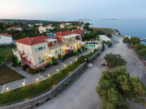 an aerial view of a street with houses and the ocean at Palaiologou Panorama Apartments in Mantamádos