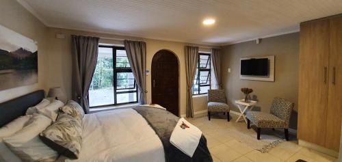 a bedroom with a bed and a large window at Dream Hills in Hillcrest