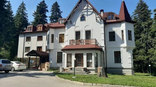 una gran casa blanca con techo en Villa Ibar en Borovets