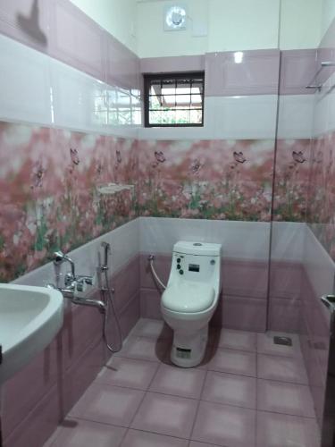 a bathroom with a toilet and a sink at Olive Inn Apartment in Alwaye