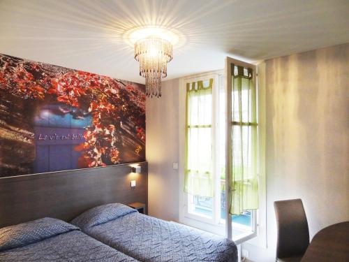 a bedroom with a bed and a large painting on the wall at Amélie Hotel in Paris