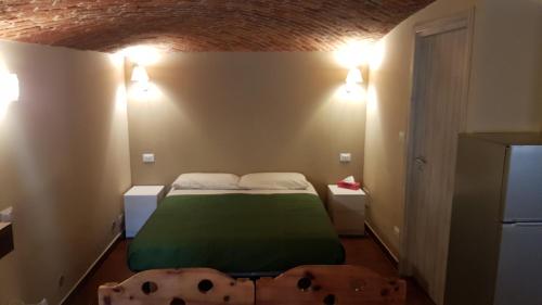 a bedroom with a bed with a green blanket at Casa Curnet in Balme