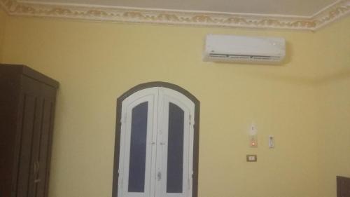 a room with a white door and a ceiling fan at King Nubian House in Aswan
