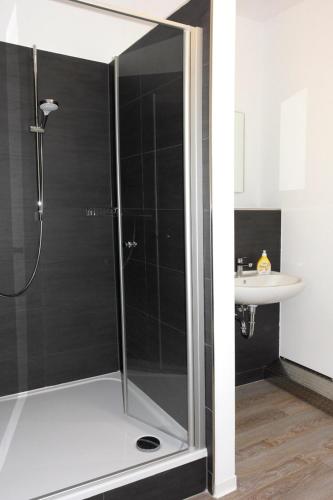 a shower with a glass door in a bathroom at Alte Post Gäste- und Monteurzimmer in Horneburg
