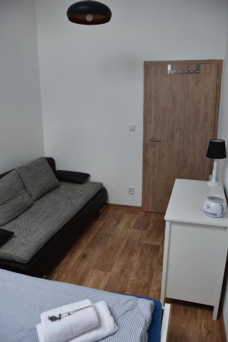 a small living room with a bed and a table at Vinný sklep U Ševčíků in Mutěnice