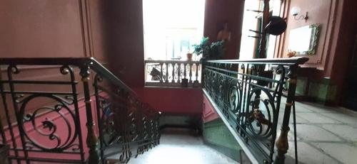 a spiral staircase in a building with a window at El Secreto Casa Art in Montevideo