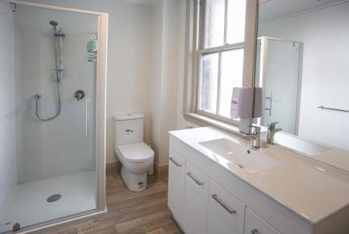 a bathroom with a sink and a shower and a toilet at The Prospect of Howick Accommodation in Auckland