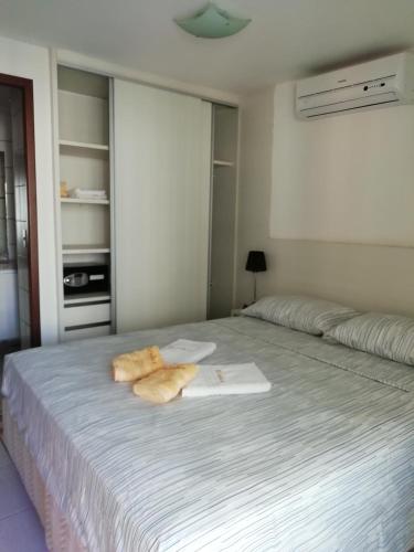 a bedroom with a bed with two towels on it at Beach Class Rosalux 707 in Fortaleza