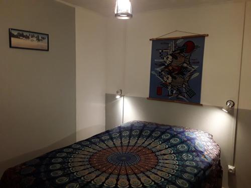 a bedroom with a bed with a colorful comforter at La case o'gecko974 in Saint-Joseph