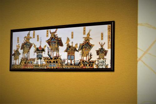 a picture hanging on a wall in a room at Hida-Takayama Michi in Takayama