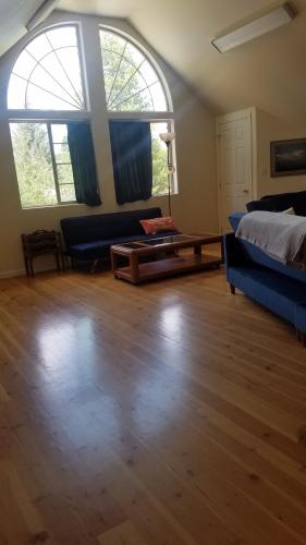 a living room with a bed and a couch and a table at The Blueberry Suite in Sandpoint