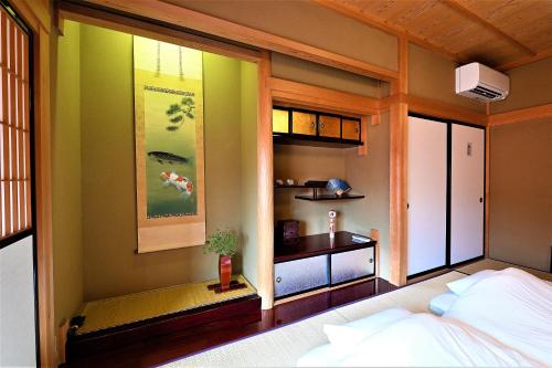 a room with a bedroom with a bed and a window at Hida-Takayama Michi in Takayama
