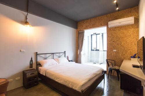 Postel nebo postele na pokoji v ubytování DoMo Yilan