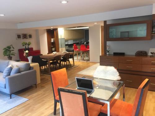 a living room with a couch and a table with a laptop at Best location in Mexico City in Mexico City
