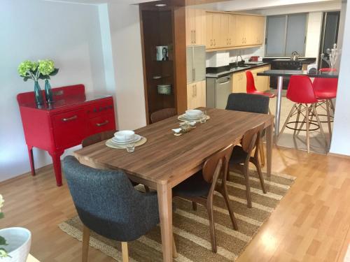 a kitchen and dining room with a wooden table and chairs at Best location in Mexico City in Mexico City