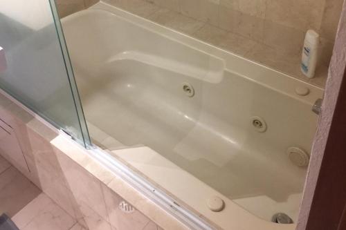 a white bath tub with a glass shower backdoor at Best location in Mexico City in Mexico City