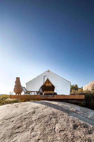 a large white tent sitting on top of a hill at Casa Misiones Glamping in Valle de Guadalupe