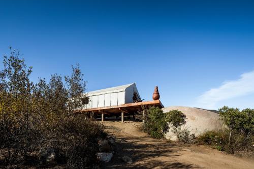 a house sitting on top of a hill at Casa Misiones Glamping in Valle de Guadalupe
