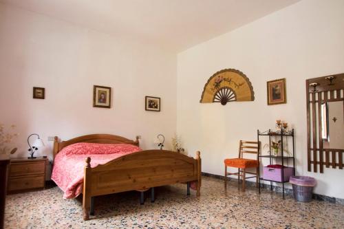 a bedroom with a bed and a table and a chair at Rustic Tuscan Apartment in Massa Marittima