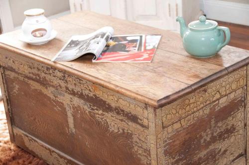 a wooden table with a tea pot and a magazine on it at The Woll on Kerripit in Barrington