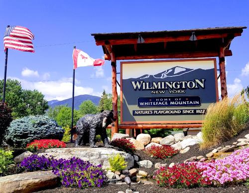 a black dog standing in front of a sign at The Wilderness Inn: Chalets in Wilmington