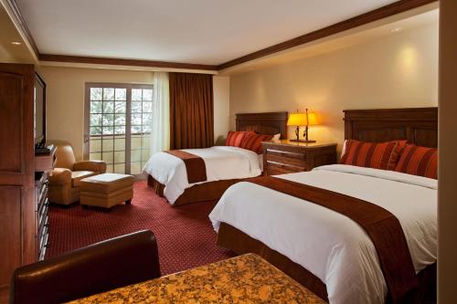 Säng eller sängar i ett rum på Tivoli Lodge