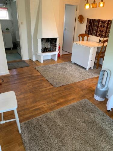 a living room with a fireplace and wooden floors at Private house Parking Garden Sea Nature in Malmö
