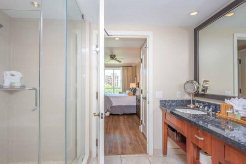 a bathroom with a glass shower and a sink at Honua Kai - Konea 642 - Ocean View from inside! 2b/2b in Kaanapali