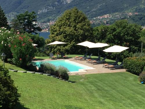 a swimming pool with umbrellas and lounge chairs and a pool at Il Poggio Di Bellagio in Bellagio