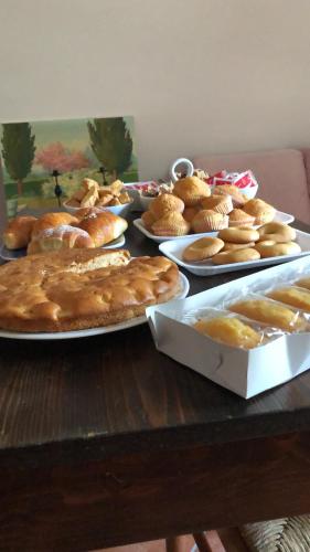 a table with plates of pies and pastries on it at Il Minotauro B&B a 5 minuti da Popoli in Vittorito