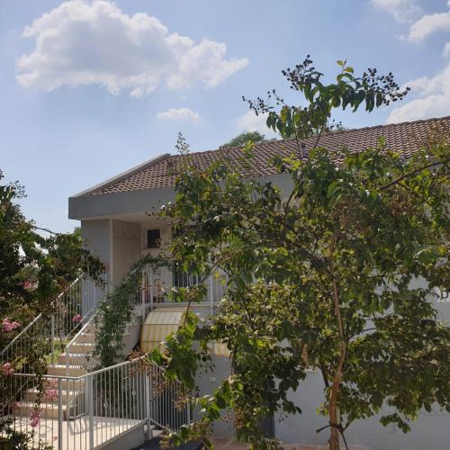 a house with a staircase leading up to it at Holiday Village Kibbutz Mizra in Mizra‘