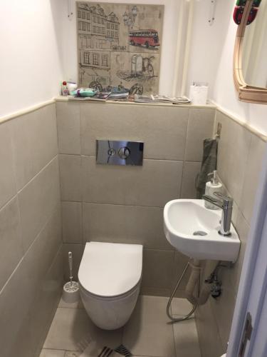 a small bathroom with a toilet and a sink at Sweet home in the heart of Sofia in Sofia