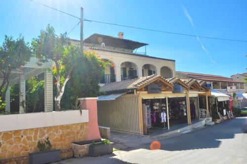 a store on the side of a street at Holiday Studio Apartments yannis on the beach of Agios Gordios in Corfu in Agios Gordios