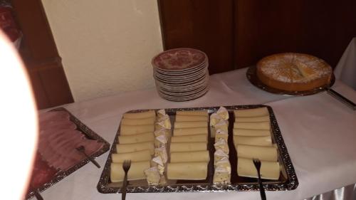 a plate of cheese and a pie on a table at Pottensteiner Stuben Pension Gasthof in Pottenstein