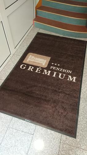 a brown rug on the floor in front of some stairs at Penzion Gremium in Bratislava