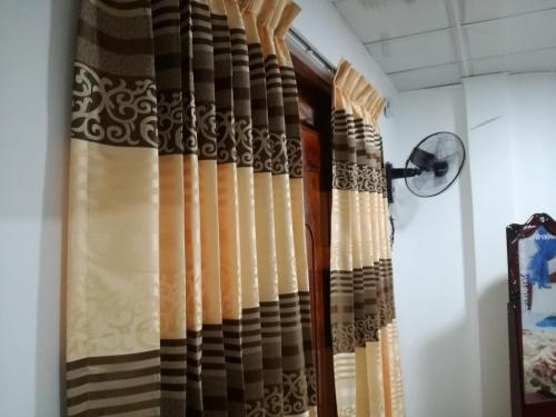 a curtain in a room with a window at Ella Sunrise in Ella