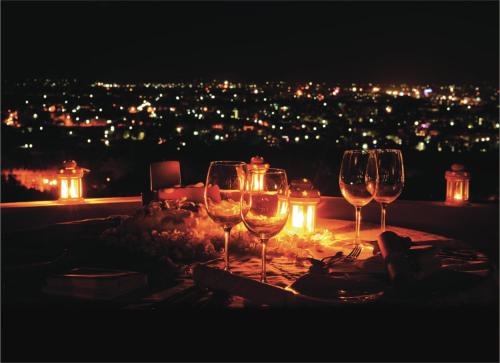a group of wine glasses sitting on a table at night at Gateway Madurai in Madurai