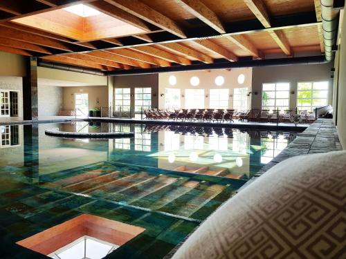 a large swimming pool with its floors and ceilings at Terme di Relilax Boutique Hotel & Spa - Adults Only in Montegrotto Terme
