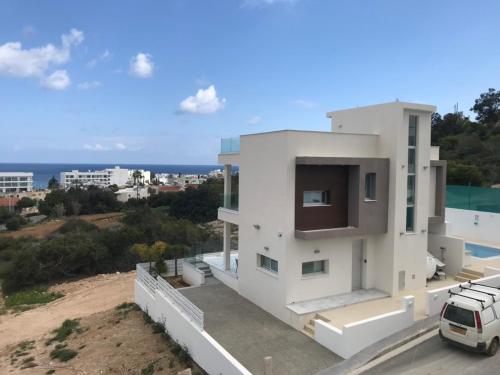 a white house with a view of the ocean at Villa Chrystalleni in Protaras