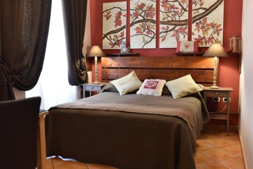 a bedroom with a large bed with two pillows on it at QuodLibet in Rome