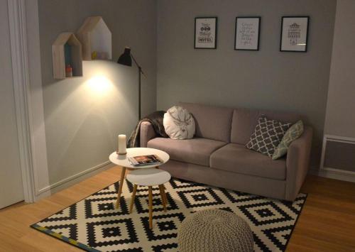 a living room with a couch and a table at Burdigala Homes - Appart de Lalande in Bordeaux