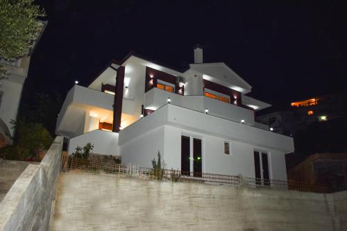 a large white house at night at Apartments Hillside in Ulcinj