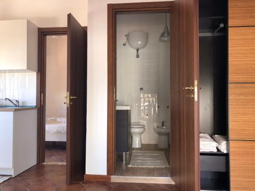 an open door to a bathroom with a toilet at Libeccio - con vista del mare a due passi in Agropoli
