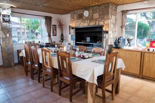 a large dining room with a table and chairs at Dornhuegel Guest Farm in Groutfontein