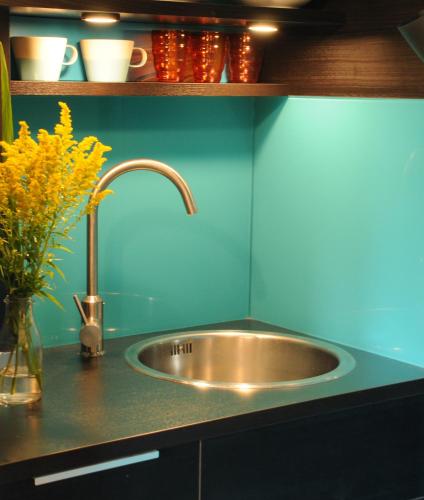a kitchen counter with a sink and a vase of flowers at Mulberry cottage in Cheltenham