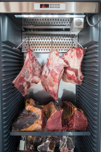 a refrigerator filled with meat and other food items at Dornhuegel Guest Farm in Groutfontein